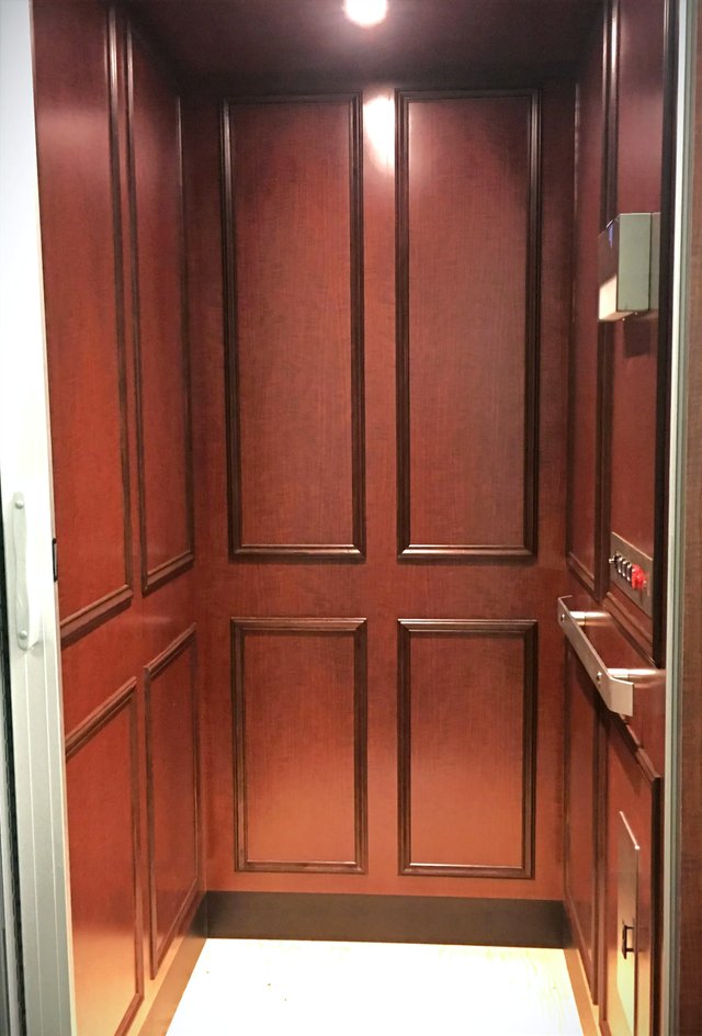 Dark red wood elevator cab